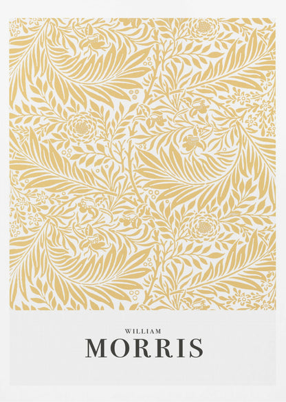 A framed exhibition-style poster of a William Morris design. The poster features an intricate, golden-yellow floral and leaf pattern on a white background. Below the pattern, the name 'WILLIAM MORRIS' is printed in black text. The entire artwork is presented in a simple black frame. Wall Art