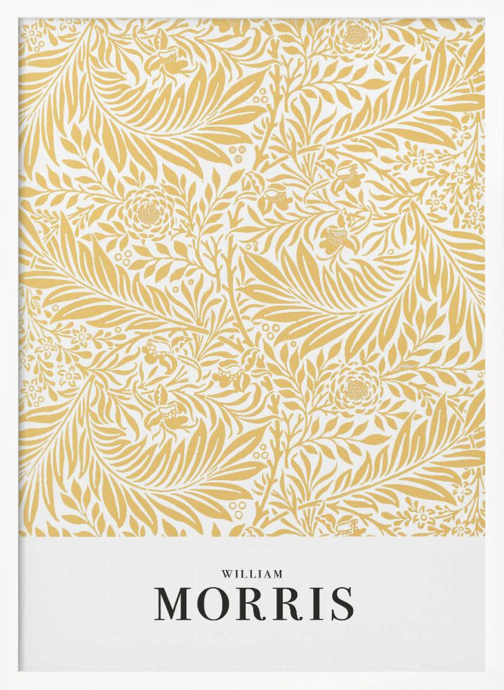 A framed exhibition-style poster of a William Morris design. The poster features an intricate, golden-yellow floral and leaf pattern on a white background. Below the pattern, the name 'WILLIAM MORRIS' is printed in black text. The entire artwork is presented in a simple black frame. Wall Art