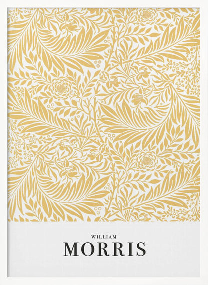 A framed exhibition-style poster of a William Morris design. The poster features an intricate, golden-yellow floral and leaf pattern on a white background. Below the pattern, the name 'WILLIAM MORRIS' is printed in black text. The entire artwork is presented in a simple black frame. Wall Art