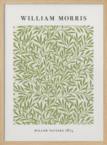 A framed art print of William Morris's 'Willow Pattern 1874'. The print features an intricate, repeating pattern of green willow branches and leaves on an off-white background, with the artist's name and pattern title in black text above and below the design. Print