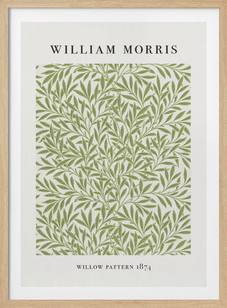 A framed art print of William Morris's 'Willow Pattern 1874'. The print features an intricate, repeating pattern of green willow branches and leaves on an off-white background, with the artist's name and pattern title in black text above and below the design. Print
