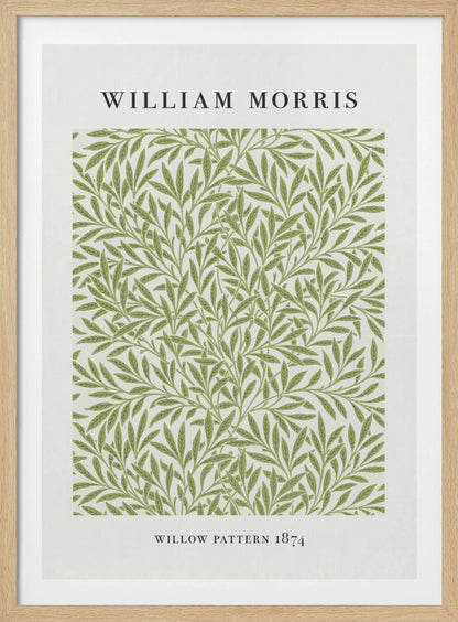 A framed art print of William Morris's 'Willow Pattern 1874'. The print features an intricate, repeating pattern of green willow branches and leaves on an off-white background, with the artist's name and pattern title in black text above and below the design. Print