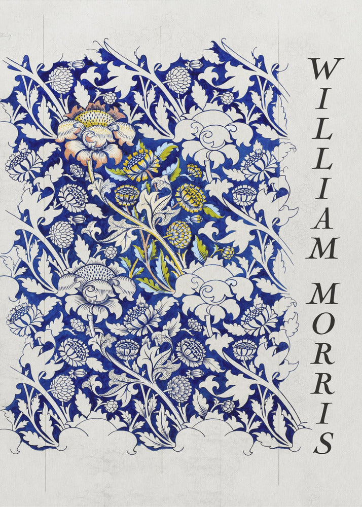 A vintage art print by William Morris featuring an intricate blue and white floral pattern on a light gray, textured background. The design swatch shows stylized flowers and acanthus leaves, with some central flowers highlighted in yellow and peach. The name 'WILLIAM MORRIS' is printed vertically in a black serif font along the right edge. The print is displayed in a thin black frame. Decor