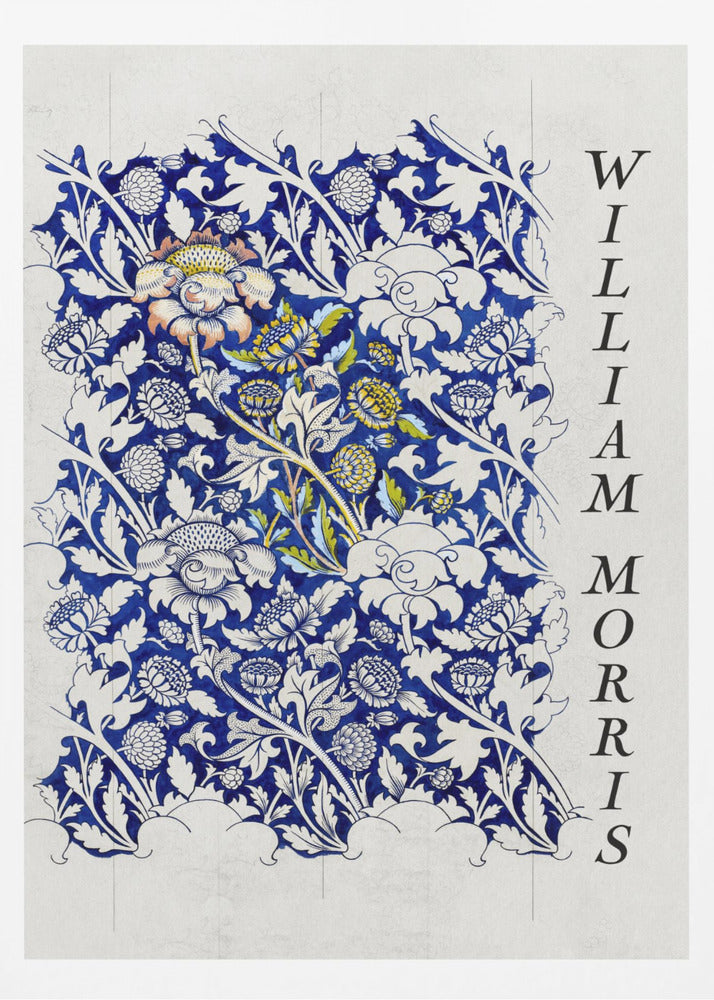 A vintage art print by William Morris featuring an intricate blue and white floral pattern on a light gray, textured background. The design swatch shows stylized flowers and acanthus leaves, with some central flowers highlighted in yellow and peach. The name 'WILLIAM MORRIS' is printed vertically in a black serif font along the right edge. The print is displayed in a thin black frame. Decor