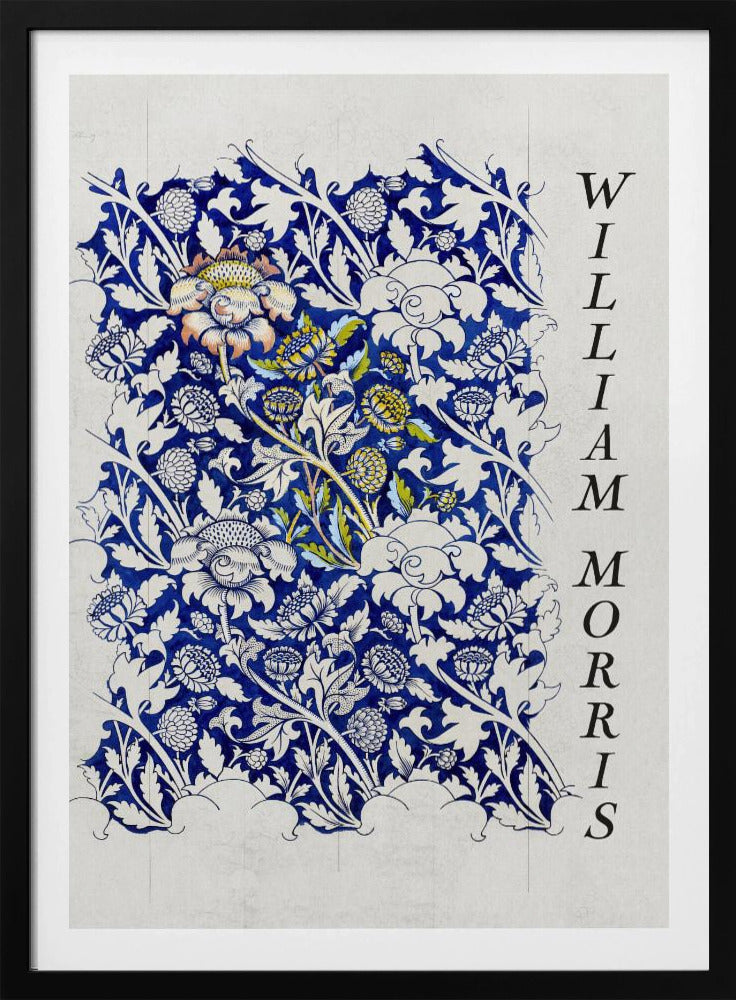 A vintage art print by William Morris featuring an intricate blue and white floral pattern on a light gray, textured background. The design swatch shows stylized flowers and acanthus leaves, with some central flowers highlighted in yellow and peach. The name 'WILLIAM MORRIS' is printed vertically in a black serif font along the right edge. The print is displayed in a thin black frame. Decor