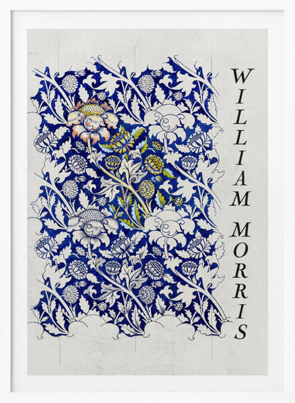 A vintage art print by William Morris featuring an intricate blue and white floral pattern on a light gray, textured background. The design swatch shows stylized flowers and acanthus leaves, with some central flowers highlighted in yellow and peach. The name 'WILLIAM MORRIS' is printed vertically in a black serif font along the right edge. The print is displayed in a thin black frame. Decor