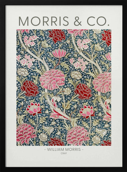 A framed art print of William Morris's 'Cray' pattern, featuring a dense floral design with large pink and red stylized flowers and foliage on a dark navy blue background. The text 'MORRIS & CO.' is above the pattern, and '- WILLIAM MORRIS - CRAY' is below. Artwork