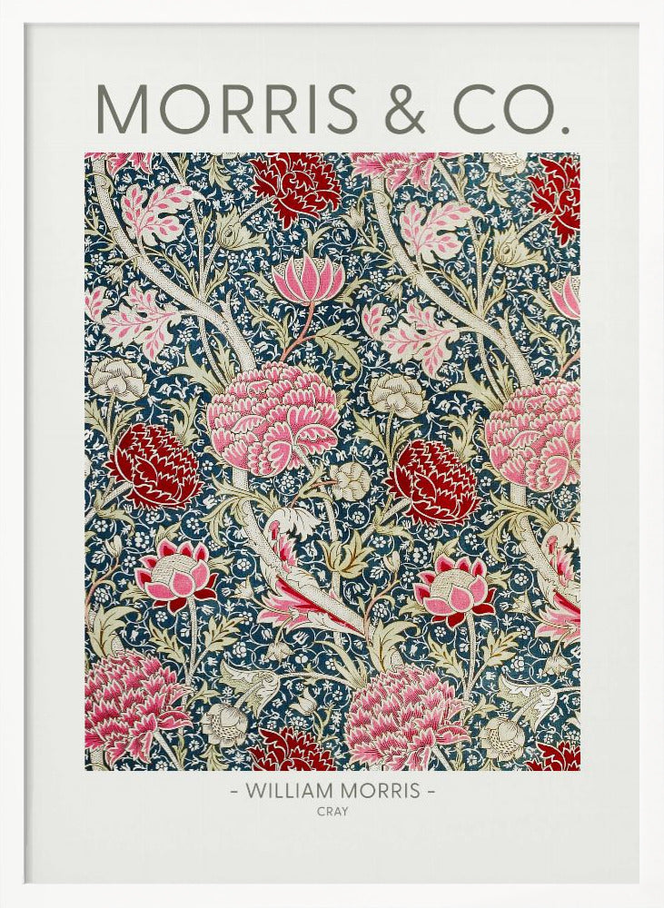 A framed art print of William Morris's 'Cray' pattern, featuring a dense floral design with large pink and red stylized flowers and foliage on a dark navy blue background. The text 'MORRIS & CO.' is above the pattern, and '- WILLIAM MORRIS - CRAY' is below. Artwork