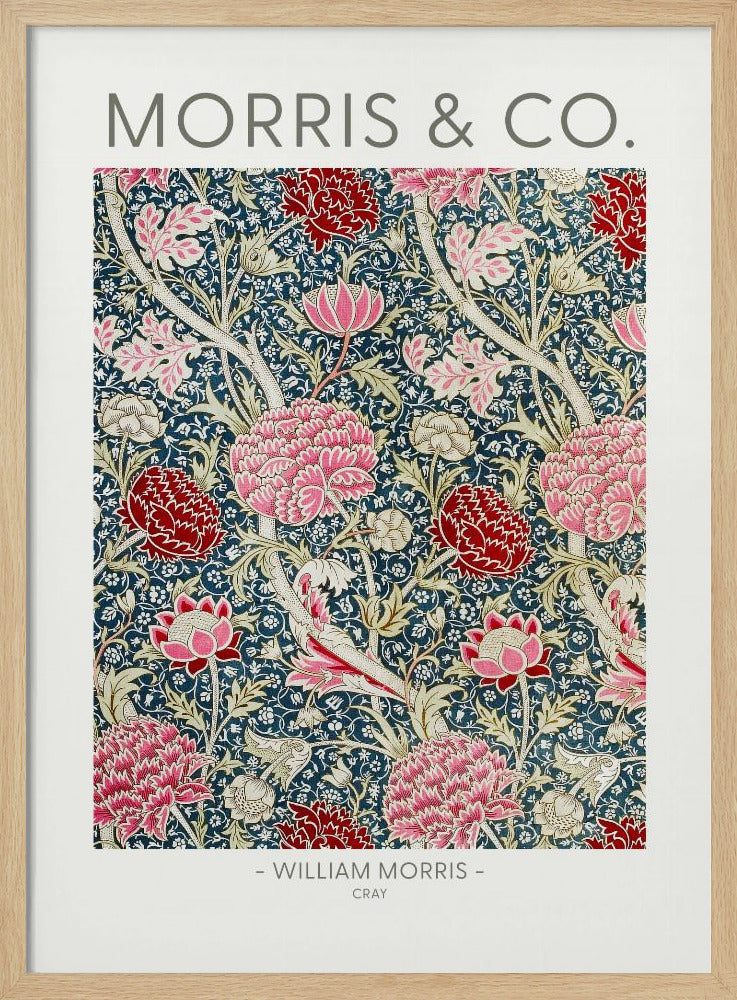 A framed art print of William Morris's 'Cray' pattern, featuring a dense floral design with large pink and red stylized flowers and foliage on a dark navy blue background. The text 'MORRIS & CO.' is above the pattern, and '- WILLIAM MORRIS - CRAY' is below. Artwork