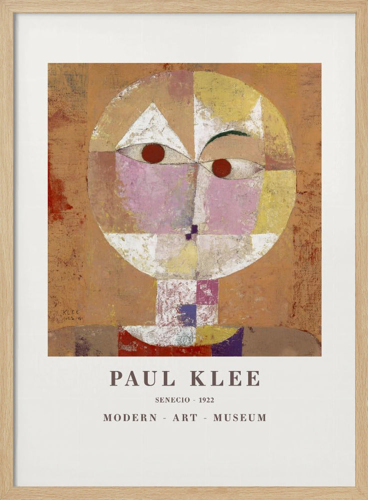 A framed museum poster of Paul Klee's 1922 painting 'Senecio'. The artwork is an abstract, geometric portrait of a human head in warm tones of orange, yellow, pink, and red against a textured brown background. The text 'PAUL KLEE', 'SENECIO - 1922', and 'MODERN - ART - MUSEUM' is printed below the image. Print