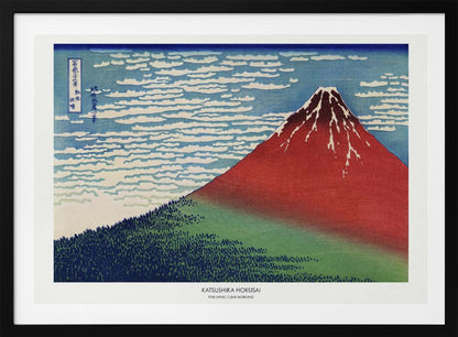 A framed Japanese woodblock print, 'Fine Wind, Clear Morning' by Katsushika Hokusai, also known as 'Red Fuji'. The print depicts a large, reddish-brown Mount Fuji with its peak lightly dusted with snow, set against a vibrant blue sky filled with white, streaky clouds. A dark green forest covers the base of the mountain. Poster