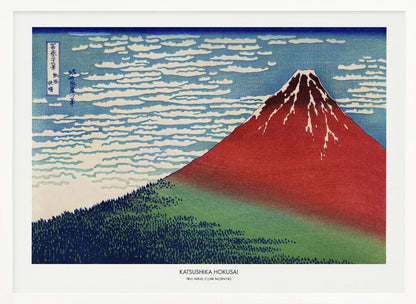 A framed Japanese woodblock print, 'Fine Wind, Clear Morning' by Katsushika Hokusai, also known as 'Red Fuji'. The print depicts a large, reddish-brown Mount Fuji with its peak lightly dusted with snow, set against a vibrant blue sky filled with white, streaky clouds. A dark green forest covers the base of the mountain. Poster
