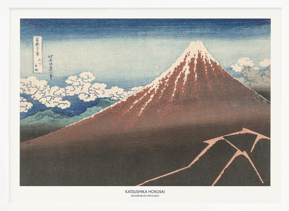 A framed Japanese woodblock print by Katsushika Hokusai titled 'Shower Below the Summit.' The print depicts a large, dark brown and reddish mountain, likely Mount Fuji, with a snow-capped peak. The sky above is a deep blue, and stylized white clouds are scattered around the mountain's slope. In the dark foreground, a jagged pink line represents a lightning strike. Artwork