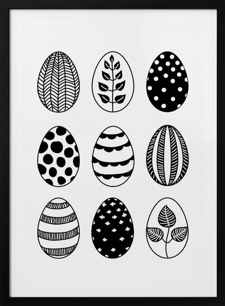 A black and white art print featuring a 3x3 grid of nine illustrated Easter eggs. Each egg has a unique, hand-drawn pattern, including polka dots, stripes, chevrons, florals, and leafy branches, all within a thin black frame. Poster