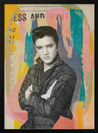 A pop art style collage of a young Elvis Presley. The portrait is in black and white, showing him with his arms crossed and a serious expression. The background is an abstract mix of colorful shapes in yellow, teal, orange, and pink, with fragments of newspaper text visible. The entire piece is covered in a light white speckle effect and is shown in a black frame. Print