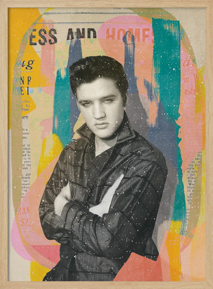 A pop art style collage of a young Elvis Presley. The portrait is in black and white, showing him with his arms crossed and a serious expression. The background is an abstract mix of colorful shapes in yellow, teal, orange, and pink, with fragments of newspaper text visible. The entire piece is covered in a light white speckle effect and is shown in a black frame. Print