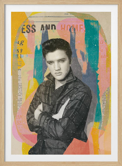 A pop art style collage of a young Elvis Presley. The portrait is in black and white, showing him with his arms crossed and a serious expression. The background is an abstract mix of colorful shapes in yellow, teal, orange, and pink, with fragments of newspaper text visible. The entire piece is covered in a light white speckle effect and is shown in a black frame. Print