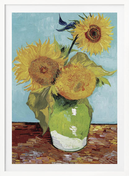 A framed reproduction of Vincent van Gogh's famous 'Sunflowers' painting, featuring three large yellow sunflowers in a green vase against a light blue background, painted in his iconic post-impressionist style with thick brushstrokes. Wall Art