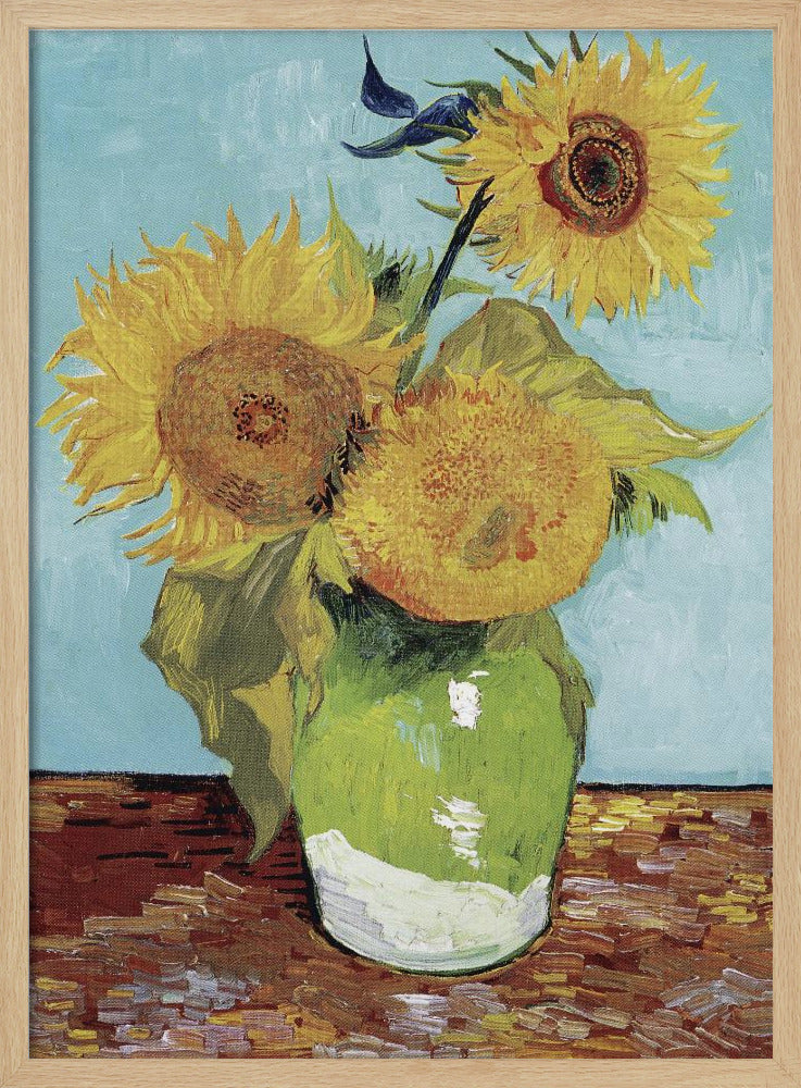 A framed reproduction of Vincent van Gogh's famous 'Sunflowers' painting, featuring three large yellow sunflowers in a green vase against a light blue background, painted in his iconic post-impressionist style with thick brushstrokes. Wall Art