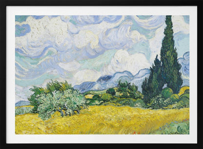 A framed print of Vincent van Gogh's painting 'Wheat Field with Cypresses.' The artwork depicts a vibrant golden wheat field under a dynamic sky filled with swirling white and blue clouds. A tall, dark green cypress tree dominates the right side, with rolling green hills and distant blue mountains in the background. Decor
