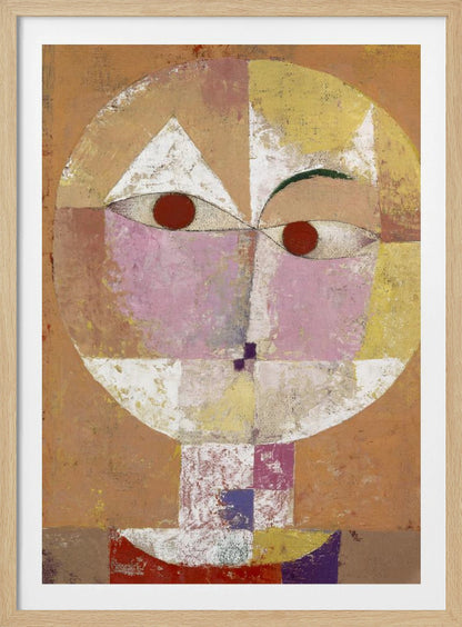 An abstract portrait painting of a stylized head, often identified as Paul Klee's 'Senecio'. The face is composed of geometric blocks of color, including pink, yellow, and white, with two prominent red circles for eyes, all set against a textured, earthy orange and brown background within a black frame. Print