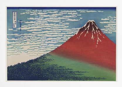 A Japanese woodblock print, Hokusai's 'Fine Wind, Clear Morning', showing a large, reddish-brown Mount Fuji with snow at its peak. Below the mountain is a dense green forest, and above is a blue sky with rows of white, stylized clouds. Print