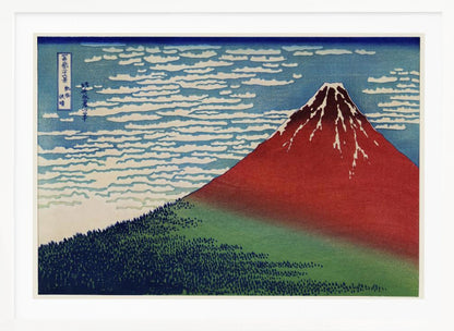 A Japanese woodblock print, Hokusai's 'Fine Wind, Clear Morning', showing a large, reddish-brown Mount Fuji with snow at its peak. Below the mountain is a dense green forest, and above is a blue sky with rows of white, stylized clouds. Print