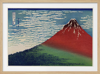 A Japanese woodblock print, Hokusai's 'Fine Wind, Clear Morning', showing a large, reddish-brown Mount Fuji with snow at its peak. Below the mountain is a dense green forest, and above is a blue sky with rows of white, stylized clouds. Print