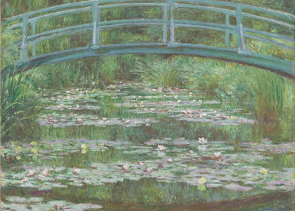 An Impressionist painting by Claude Monet depicting a green Japanese-style footbridge arching over a tranquil pond filled with blooming water lilies and lily pads, all rendered in soft, dappled brushstrokes and framed in a modern silver frame. Print