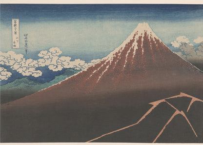 A classic Japanese ukiyo-e woodblock print by Hokusai, 'Thunderstorm Beneath the Summit', depicting a reddish-brown Mount Fuji with its snowy peak against a blue sky. Stylized clouds gather below the summit, and a fork of lightning illuminates the dark landscape at the mountain's base. Print