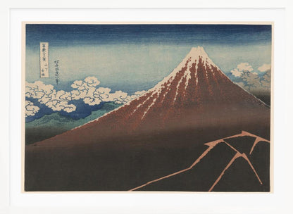 A classic Japanese ukiyo-e woodblock print by Hokusai, 'Thunderstorm Beneath the Summit', depicting a reddish-brown Mount Fuji with its snowy peak against a blue sky. Stylized clouds gather below the summit, and a fork of lightning illuminates the dark landscape at the mountain's base. Print