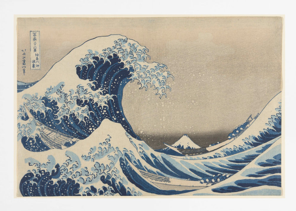 The Great Wave off Kanagawa by Hokusai, a famous Japanese ukiyo-e woodblock print. It depicts a massive, deep blue wave with claw-like white foam cresting and about to crash over three boats, with a small, snow-capped Mount Fuji visible in the background under a pale, graded sky. Artwork
