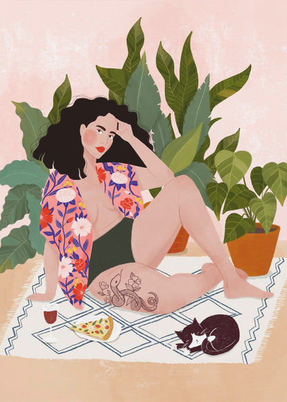 An illustration of a woman with dark curly hair relaxing on a patterned blanket indoors. She is wearing a green swimsuit and a pink floral shirt, with a prominent snake tattoo on her thigh. Next to her is a slice of pizza, a glass of red wine, and a sleeping black and white cat, all set against a backdrop of large green houseplants and a pink wall. Artwork