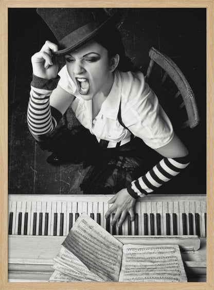 A dramatic black and white high-angle photograph of a woman in a top hat and striped arm warmers, shouting or singing passionately while seated at a piano with sheet music. Print