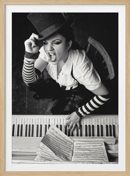 A dramatic black and white high-angle photograph of a woman in a top hat and striped arm warmers, shouting or singing passionately while seated at a piano with sheet music. Print