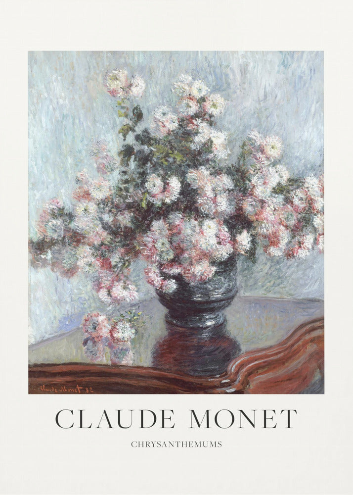 A framed art print of Claude Monet's impressionist painting, 'Chrysanthemums.' The painting features a lush bouquet of pink and white chrysanthemums in a dark vase resting on a reflective, mahogany-colored table against a light blue, textured background. The print includes a white border with the artist's name and the title below the artwork, all enclosed in a simple black frame. Print