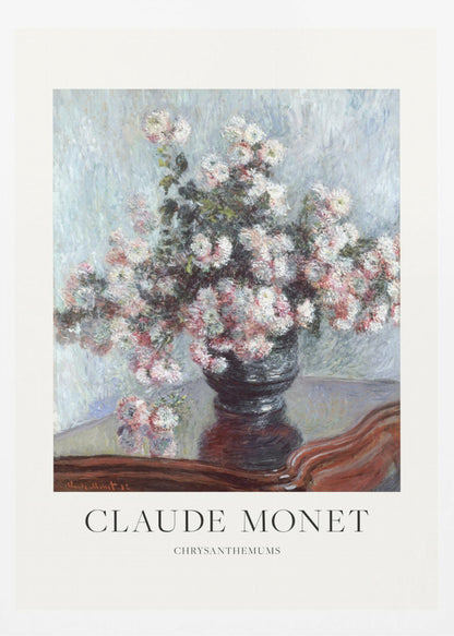 A framed art print of Claude Monet's impressionist painting, 'Chrysanthemums.' The painting features a lush bouquet of pink and white chrysanthemums in a dark vase resting on a reflective, mahogany-colored table against a light blue, textured background. The print includes a white border with the artist's name and the title below the artwork, all enclosed in a simple black frame. Print