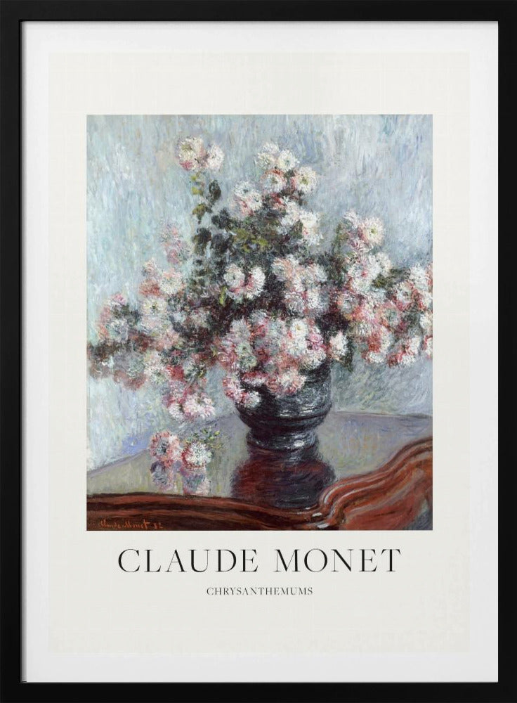 A framed art print of Claude Monet's impressionist painting, 'Chrysanthemums.' The painting features a lush bouquet of pink and white chrysanthemums in a dark vase resting on a reflective, mahogany-colored table against a light blue, textured background. The print includes a white border with the artist's name and the title below the artwork, all enclosed in a simple black frame. Print