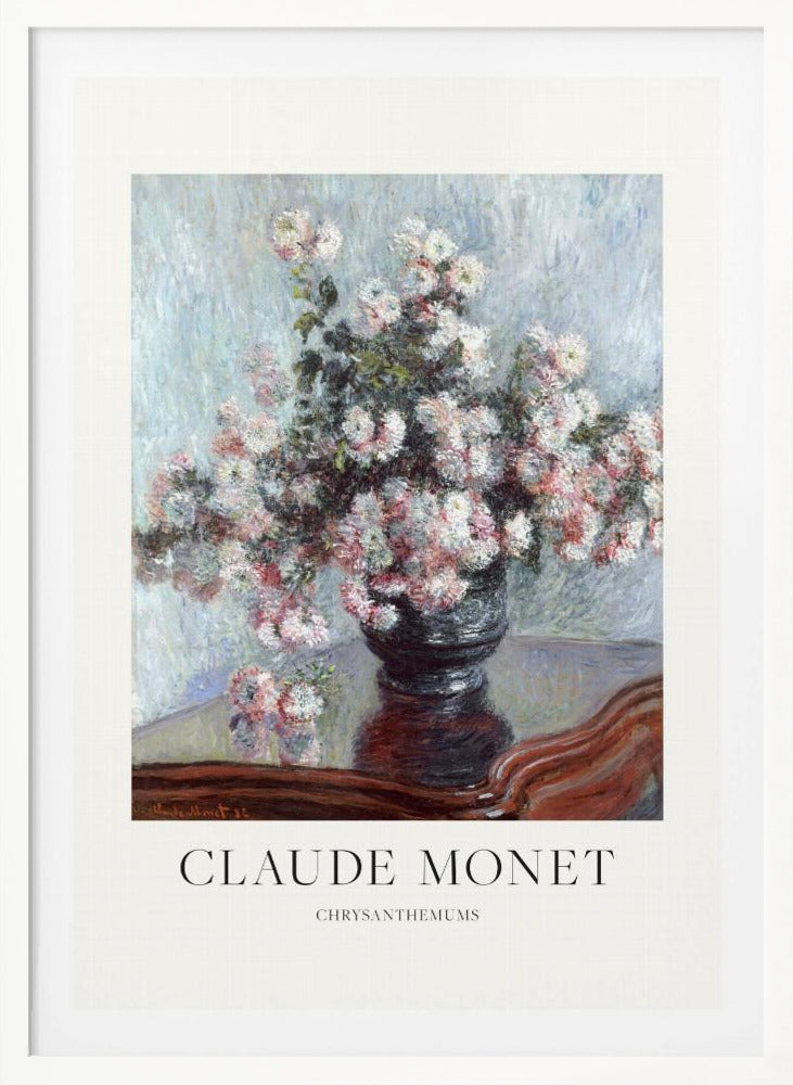 A framed art print of Claude Monet's impressionist painting, 'Chrysanthemums.' The painting features a lush bouquet of pink and white chrysanthemums in a dark vase resting on a reflective, mahogany-colored table against a light blue, textured background. The print includes a white border with the artist's name and the title below the artwork, all enclosed in a simple black frame. Print