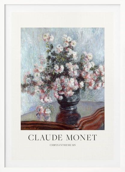 A framed art print of Claude Monet's impressionist painting, 'Chrysanthemums.' The painting features a lush bouquet of pink and white chrysanthemums in a dark vase resting on a reflective, mahogany-colored table against a light blue, textured background. The print includes a white border with the artist's name and the title below the artwork, all enclosed in a simple black frame. Print
