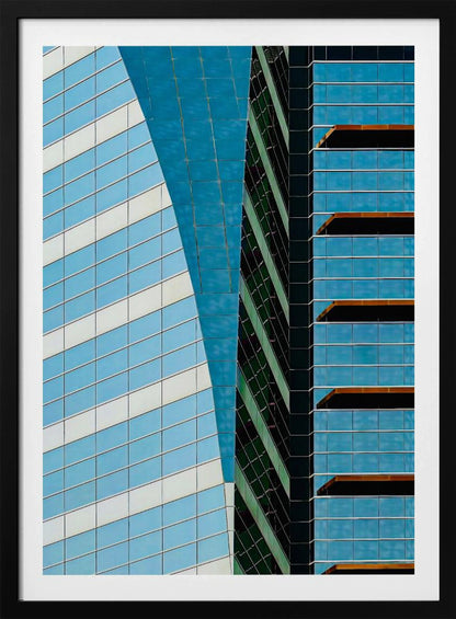 An abstract close-up photograph of modern skyscrapers, featuring a dynamic composition of intersecting lines and geometric patterns. The facades consist of blue, white, and dark green reflective glass, creating a visually complex play of light, shadow, and color. Wall Art