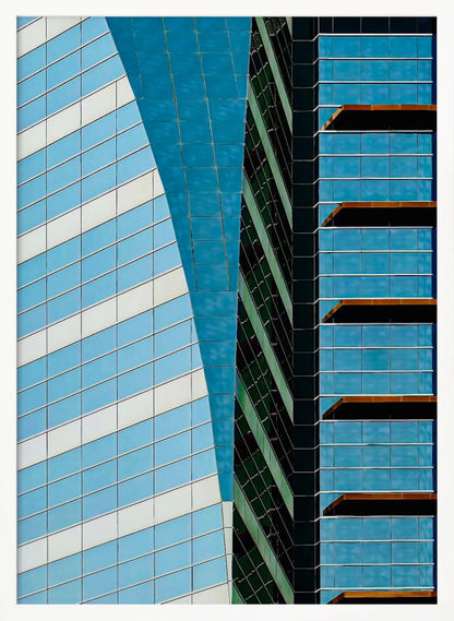 An abstract close-up photograph of modern skyscrapers, featuring a dynamic composition of intersecting lines and geometric patterns. The facades consist of blue, white, and dark green reflective glass, creating a visually complex play of light, shadow, and color. Wall Art