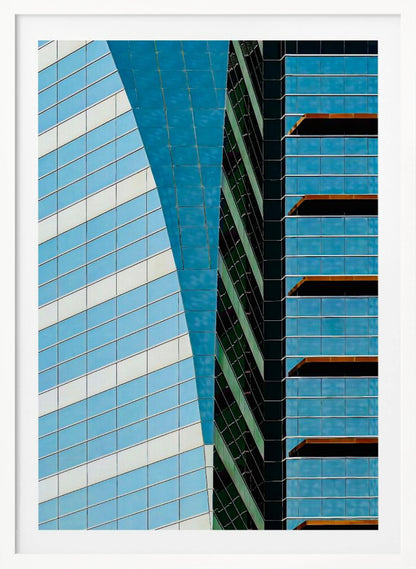 An abstract close-up photograph of modern skyscrapers, featuring a dynamic composition of intersecting lines and geometric patterns. The facades consist of blue, white, and dark green reflective glass, creating a visually complex play of light, shadow, and color. Wall Art