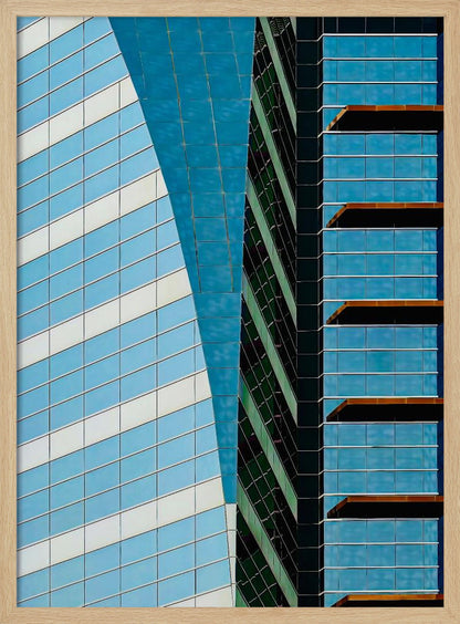 An abstract close-up photograph of modern skyscrapers, featuring a dynamic composition of intersecting lines and geometric patterns. The facades consist of blue, white, and dark green reflective glass, creating a visually complex play of light, shadow, and color. Wall Art