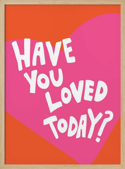 A framed art print with the text 'Have you loved today?' in a playful white font. The text is centered on a large pink heart which is set against a vibrant orange background. Artwork