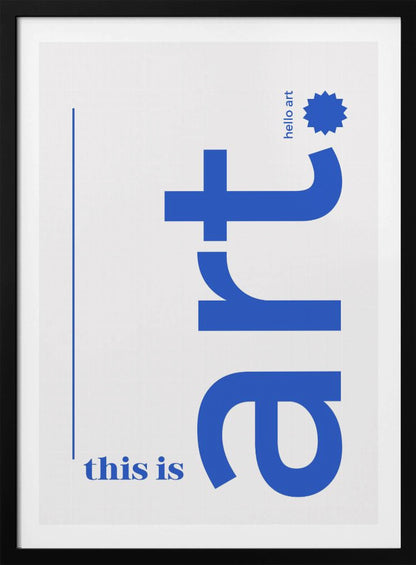 A minimalist art print in a black frame, featuring a white background with blue text. The word 'art' is written vertically in a large, bold lowercase font. To the left, smaller text reads 'this is'. At the top right, 'hello art' is written next to a blue starburst graphic. Wall Art