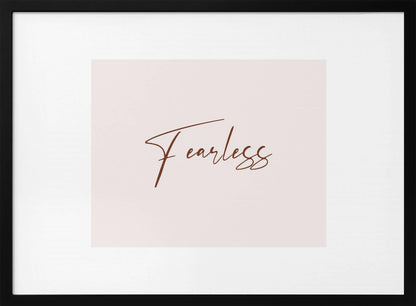 A framed artwork featuring the word 'Fearless' in a flowing brown script font on a pale pink background. The piece is surrounded by a white mat and a textured silver frame. Wall Art