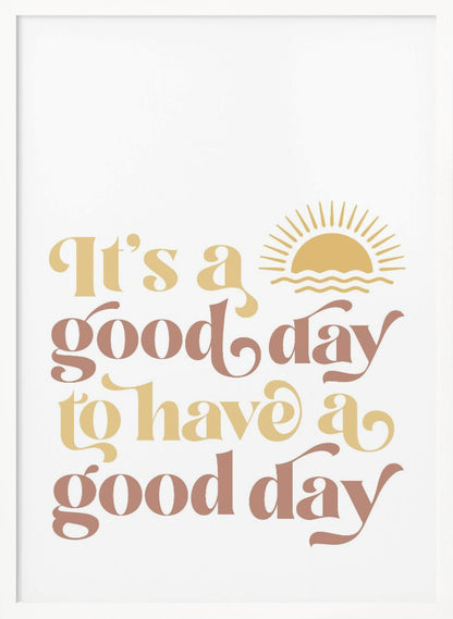 A framed art print with a white background featuring the quote 'It's a good day to have a good day' in a retro, curvy font. The text color alternates between terracotta brown and mustard yellow. Above the text is a small yellow icon of a sun rising over waves. Wall Art