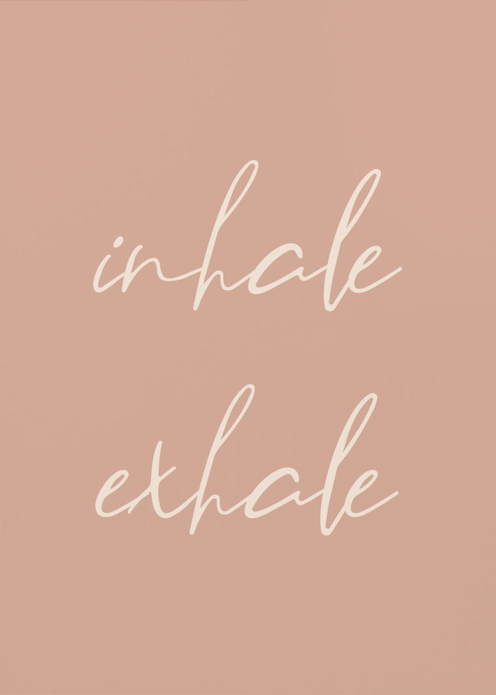 A minimalist framed poster featuring the words 'inhale' and 'exhale' in a flowing white script font, stacked vertically against a solid dusty pink background. Poster