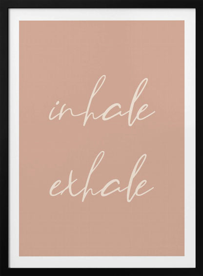 A minimalist framed poster featuring the words 'inhale' and 'exhale' in a flowing white script font, stacked vertically against a solid dusty pink background. Poster